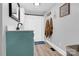 Bathroom featuring a blue vanity, mirror, shower with curtain and wall decorations at 803 N Walnut St, Kannapolis, NC 28081