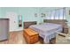Cozy bedroom with light blue walls, hardwood style floors, a comfortable bed and a wooden chest at the foot at 803 N Walnut St, Kannapolis, NC 28081