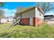 Back of house with stairs. Brick foundation and adjacent apartment building at 803 N Walnut St, Kannapolis, NC 28081