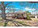 Charming single-story home featuring a inviting front porch, landscaped yard, and mature trees at 803 N Walnut St, Kannapolis, NC 28081