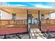 Charming front porch with a wooden deck, seating, and play area for children at 803 N Walnut St, Kannapolis, NC 28081