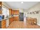Eat-in kitchen with wood cabinets, modern appliances, and adjacent dining area with wood table at 803 N Walnut St, Kannapolis, NC 28081