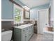 Bathroom features a double sink vanity and rustic sliding mirror at 828 N 6Th St, Albemarle, NC 28001