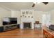 Comfortable living room showcasing a brick fireplace and hardwood floors at 828 N 6Th St, Albemarle, NC 28001