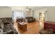 Bright living room with hardwood floors, large windows, and cozy seating at 828 N 6Th St, Albemarle, NC 28001