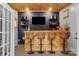 Finished bar features a custom counter, bar stools, TV and stylish decor at 8819 Kishorn Ct, Charlotte, NC 28215