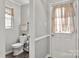 Clean and functional half bathroom with modern fixtures and easy access to the outside at 8819 Kishorn Ct, Charlotte, NC 28215