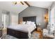 Comfortable primary bedroom with vaulted ceiling, ceiling fan, and private closet at 8819 Kishorn Ct, Charlotte, NC 28215