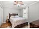 Bedroom with ceiling fan and light fixture, hardwood floors, and natural light at 8819 Kishorn Ct, Charlotte, NC 28215