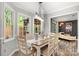 Inviting dining room with natural light, a farmhouse-style table, and views into the living room at 8819 Kishorn Ct, Charlotte, NC 28215