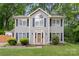 Charming two-story home with gray siding, blue shutters, and a well-manicured front yard at 8819 Kishorn Ct, Charlotte, NC 28215