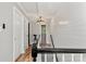 Upstairs hallway featuring shiplap accent wall, lighting, and wood floors at 8819 Kishorn Ct, Charlotte, NC 28215