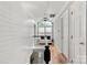 Upstairs hallway features wood floors, natural light, and white doors, creating an inviting space at 8819 Kishorn Ct, Charlotte, NC 28215