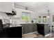 Bright kitchen with white cabinets, modern appliances, and a view into the dining area at 8819 Kishorn Ct, Charlotte, NC 28215