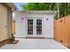 Outbuilding features french doors and modern lighting, creating a clean and functional space at 8819 Kishorn Ct, Charlotte, NC 28215