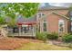 Charming backyard deck and patio, surrounded by mature trees and blossoming plants at 8905 Landsdowne Ave, Harrisburg, NC 28075