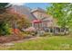 Well-maintained backyard with patio, deck, garden area, and mature landscaping at 8905 Landsdowne Ave, Harrisburg, NC 28075