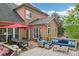 Spacious backyard patio with a dining table, comfortable seating, and a lush green view at 8905 Landsdowne Ave, Harrisburg, NC 28075