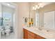 Bathroom featuring a well-lit vanity area, a toilet, and a shower behind a curtain at 8905 Landsdowne Ave, Harrisburg, NC 28075