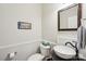 Powder room with granite countertop sink, modern fixtures, and neutral paint at 8905 Landsdowne Ave, Harrisburg, NC 28075