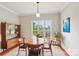 Dining room with hardwood floors, a wooden table, and large window letting in natural light at 8905 Landsdowne Ave, Harrisburg, NC 28075