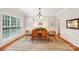 Formal dining room with hardwood floors, natural light, and classic chandelier at 8905 Landsdowne Ave, Harrisburg, NC 28075