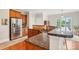 Kitchen with wooden cabinets, stainless steel appliances, and a peninsula counter at 8905 Landsdowne Ave, Harrisburg, NC 28075