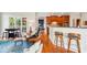View of open kitchen with wooden bar stools in the foreground, transitioning to the living room at 8905 Landsdowne Ave, Harrisburg, NC 28075