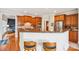 Kitchen view showcasing bar seating, stainless steel appliances and wooden cabinetry at 8905 Landsdowne Ave, Harrisburg, NC 28075
