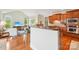 Open concept kitchen featuring wood cabinets, granite counters, and a breakfast bar at 8905 Landsdowne Ave, Harrisburg, NC 28075