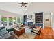 Spacious living room with built-in shelving, fireplace, hardwood floors, and exterior views at 8905 Landsdowne Ave, Harrisburg, NC 28075