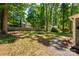 Large backyard features a wooded lot, a storage shed, and plant beds at 901 Southland Rd, Huntersville, NC 28078
