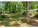 Large backyard with lush greenery and mature trees, providing a private and peaceful outdoor retreat at 901 Southland Rd, Huntersville, NC 28078