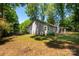 Expansive backyard featuring a well-maintained lawn, mature trees, and privacy fence, offering a serene outdoor space at 901 Southland Rd, Huntersville, NC 28078
