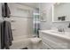 Well-lit bathroom features a shower-tub combo with tiled walls and modern vanity at 901 Southland Rd, Huntersville, NC 28078