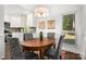 Charming dining area with a wooden table, upholstered chairs, and a view into the kitchen at 901 Southland Rd, Huntersville, NC 28078