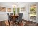 Cozy dining area featuring stylish chairs, a wooden table, and a view into the outdoor area at 901 Southland Rd, Huntersville, NC 28078