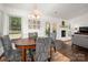 Bright dining room with hardwood floors, decorative lighting, and white painted brick fireplace at 901 Southland Rd, Huntersville, NC 28078