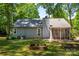 Exterior view of home from the yard featuring siding, plant beds, and a screened porch at 901 Southland Rd, Huntersville, NC 28078