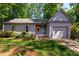 Charming one-story home with a well-manicured lawn, mature trees, and inviting front entrance at 901 Southland Rd, Huntersville, NC 28078