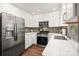Modern kitchen featuring stainless steel appliances, white cabinets, and sleek countertops at 901 Southland Rd, Huntersville, NC 28078