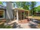 The screened porch is accessed from a concrete patio, and has a view of the yard at 901 Southland Rd, Huntersville, NC 28078