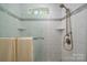Updated shower with neutral tile, built-in shelves, and accessible handrails at 901 Southland Rd, Huntersville, NC 28078