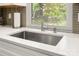 Kitchen sink showcasing the stainless fixtures, white countertop, and neutral backsplash at 901 Southland Rd, Huntersville, NC 28078