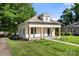 Street view of a white bungalow with a covered porch and manicured lawn on a sunny day at 906 Church St, Kings Mountain, NC 28086