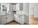 Charming kitchen featuring granite countertops, stainless steel sink and white cabinets at 906 Church St, Kings Mountain, NC 28086