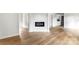 Open living room with a modern electric fireplace feature, light-toned wood floors and hallway access at 906 Church St, Kings Mountain, NC 28086