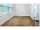 Cozy bedroom with a large window providing natural light and plush neutral carpeting at 911 Balsam Ter, Charlotte, NC 28214