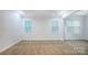 Carpeted room with two windows, providing ample natural light and a view of the outside at 911 Balsam Ter, Charlotte, NC 28214