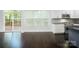 Modern kitchen featuring white cabinets, stainless steel appliances, granite countertops, and a view of the outdoor deck at 911 Balsam Ter, Charlotte, NC 28214